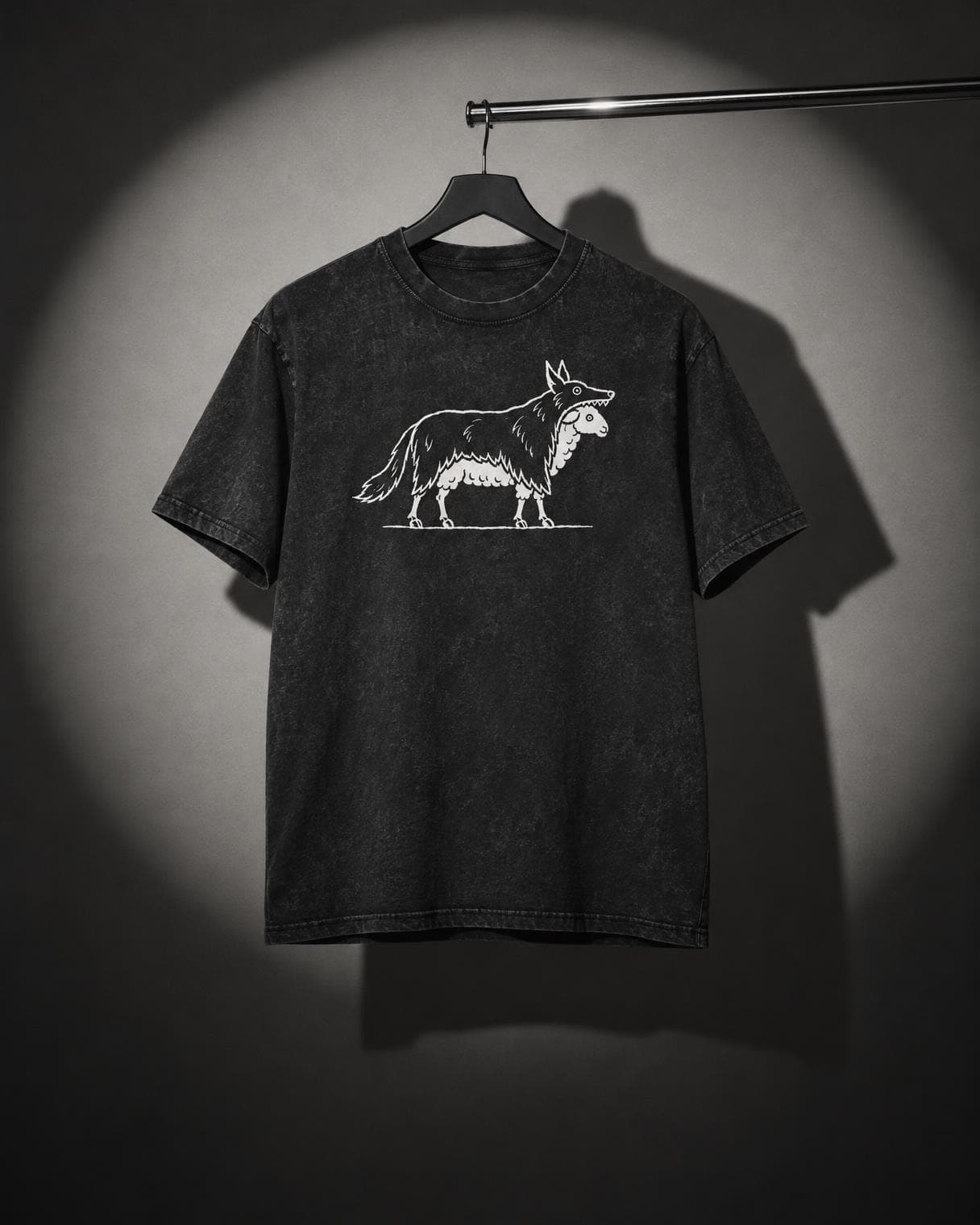 Among Wolves Tee hanging on a rail under a studio spotlight